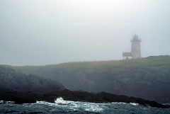 Libby Island Lighthouse on Rocky Hilltop in Dense Fog